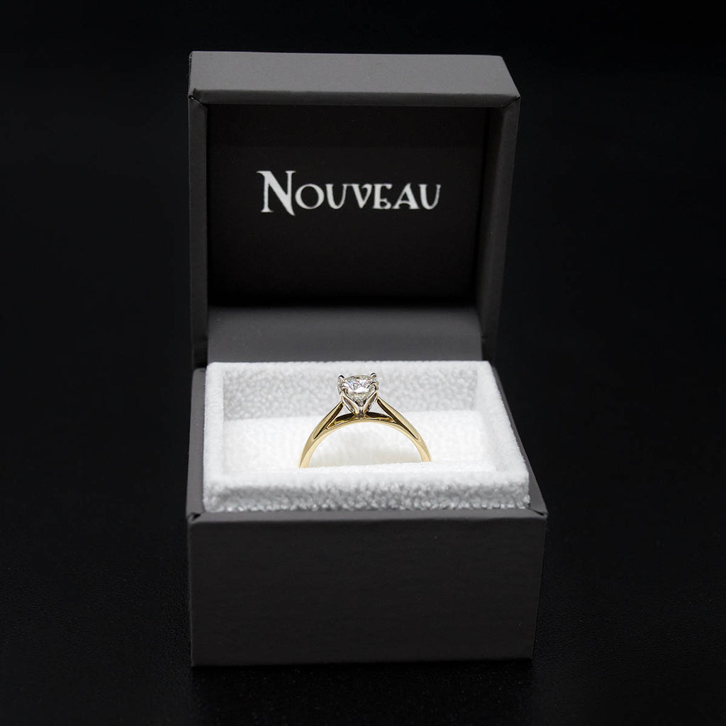 18ct Gold Petal Solitaire Diamond Engagement Ring in a box, sold at Nouveau Jewellers in Manchester