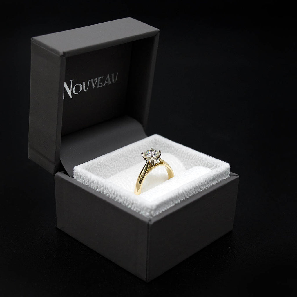 18ct Gold Petal Solitaire Diamond Engagement Ring in a box side profile, sold at Nouveau Jewellers in Manchester