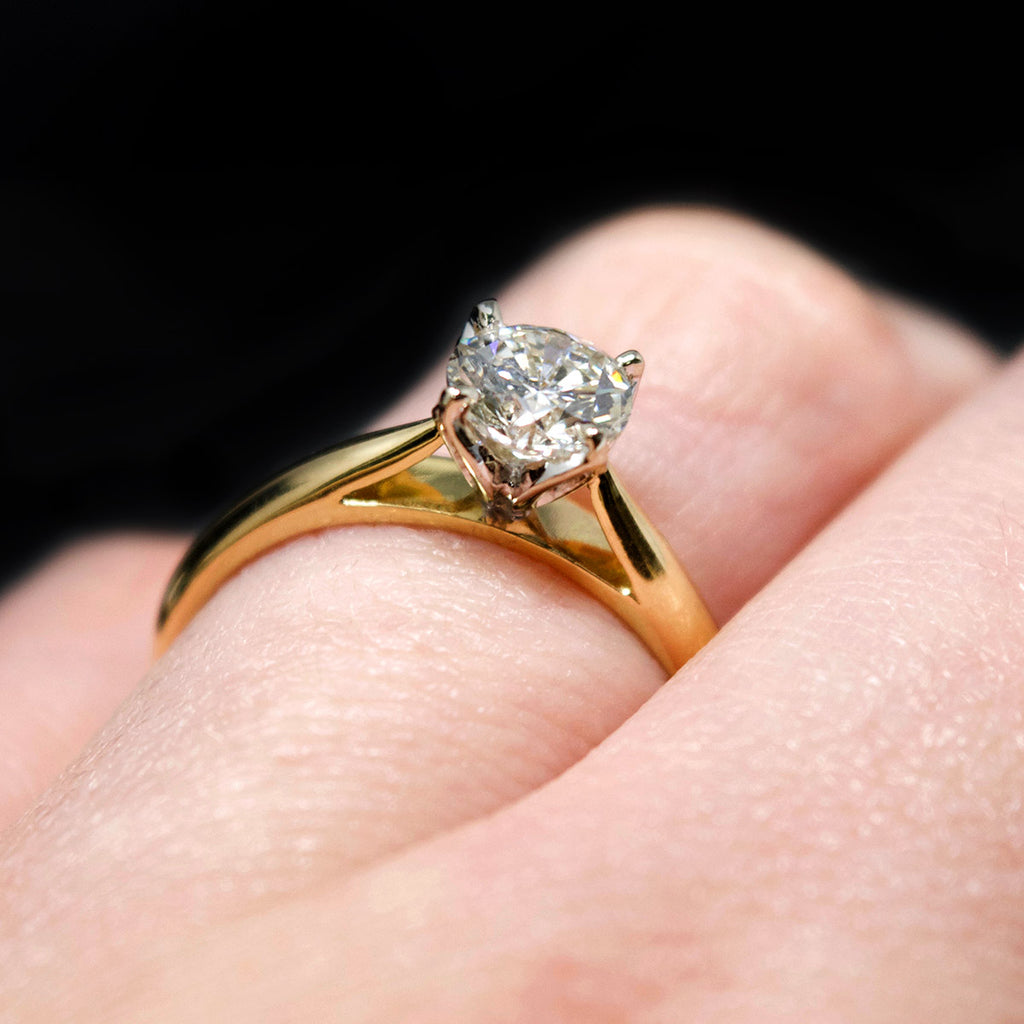18ct Gold Petal Solitaire Diamond Engagement Ring on finger, sold at Nouveau Jewellers in Manchester