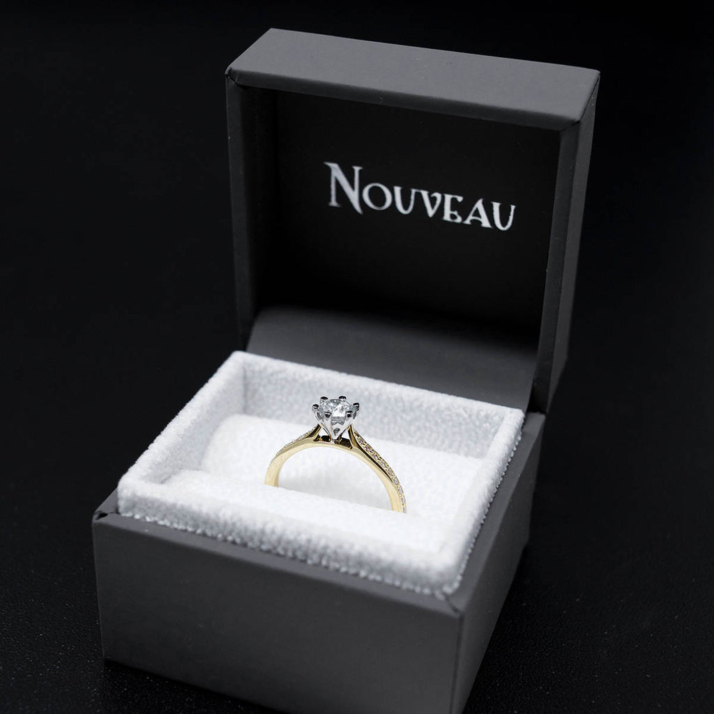 18ct Yellow Gold Solitaire Diamond Engagement Ring with Diamond Shoulders in a box, sold at Nouveau Jewellers in Manchester