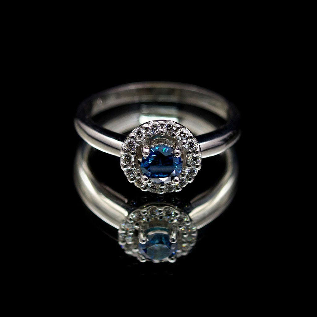 18ct White Gold Blue Diamond Halo Engagement Ring, sold at Nouveau Jewellers in Manchester
