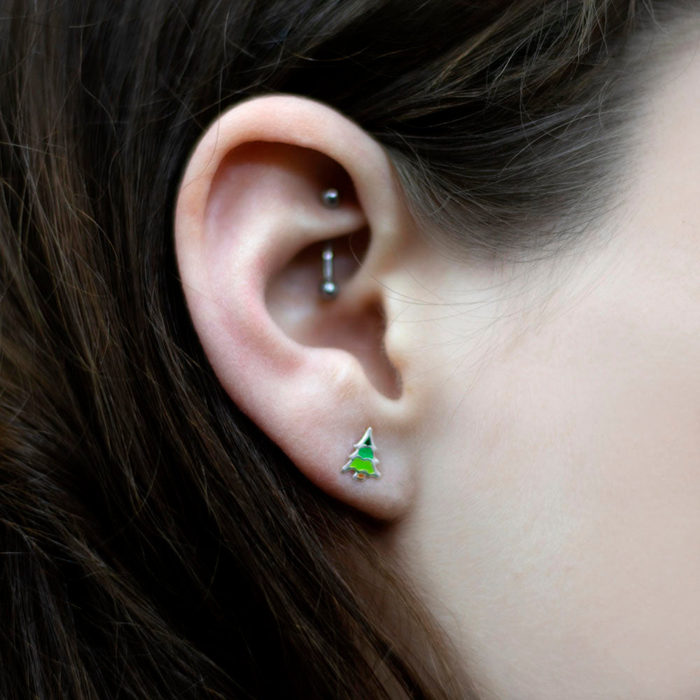 925 Silver Christmas Tree Stud Earrings on a girls ear, sold at Nouveau Jewellers in Manchester