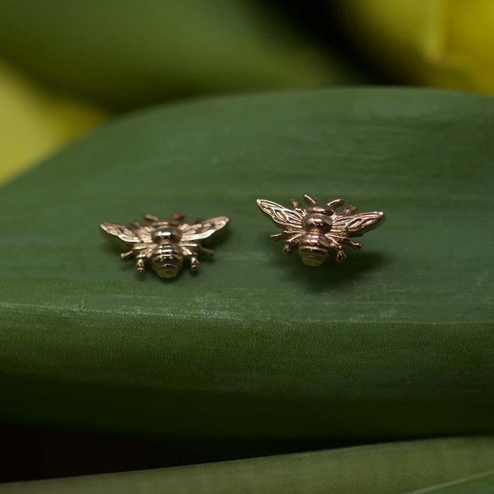 Rose Gold Manchester Bee Studs on green background, Beehive Collection exclusively sold at Nouveau Jewellers in Manchester